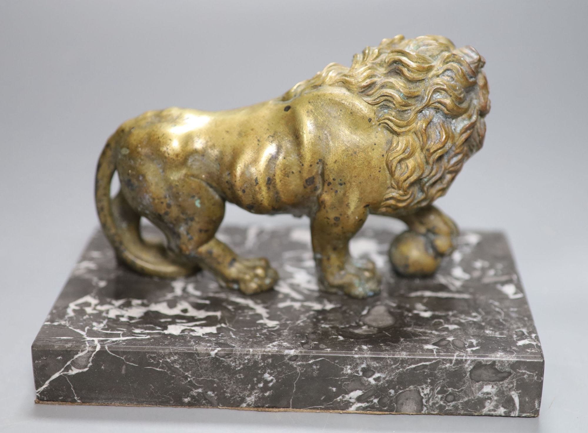 A 19th century bronze of a lion on a marble base, length 19cm